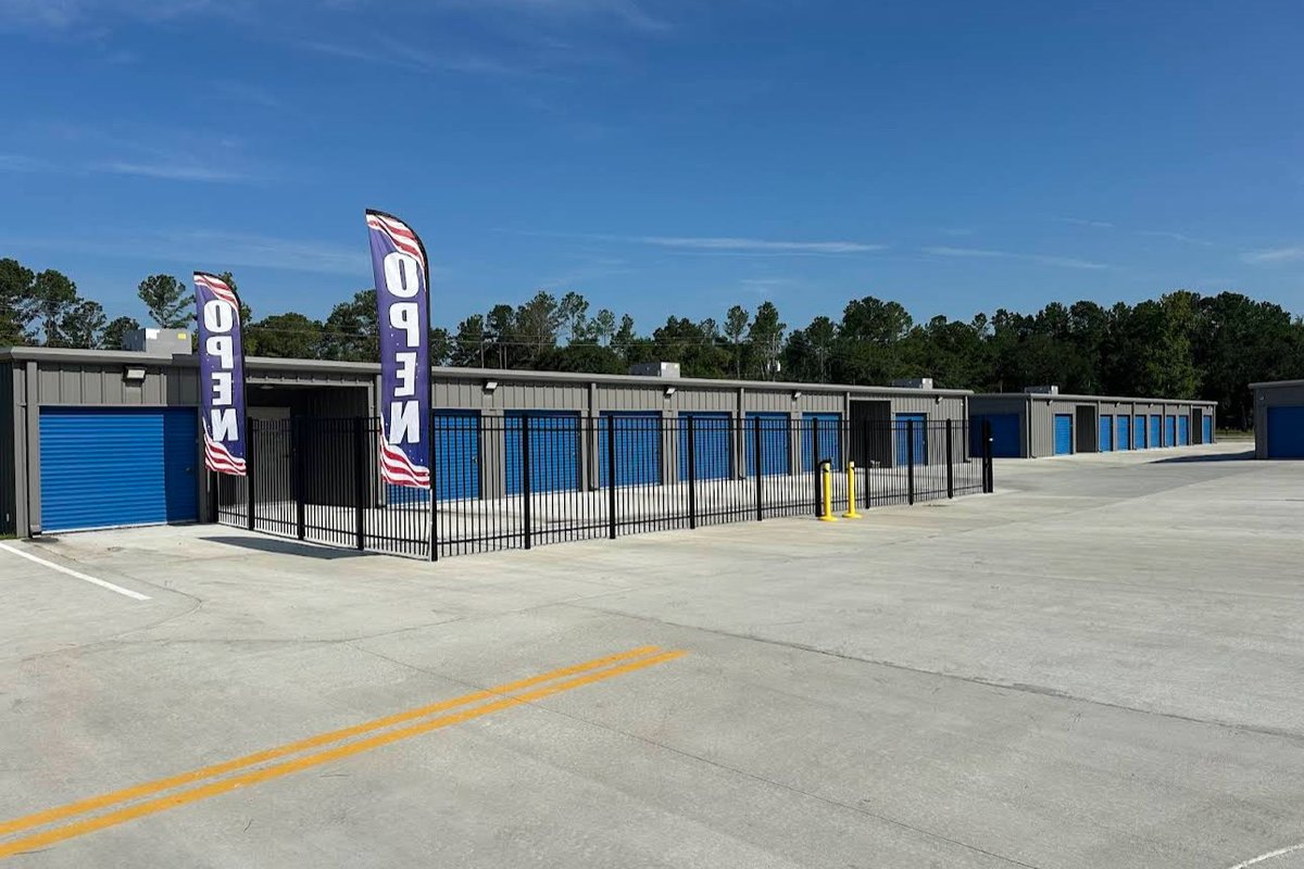 Self-storage facility exterior with roll-up doors and paved drive aisles
