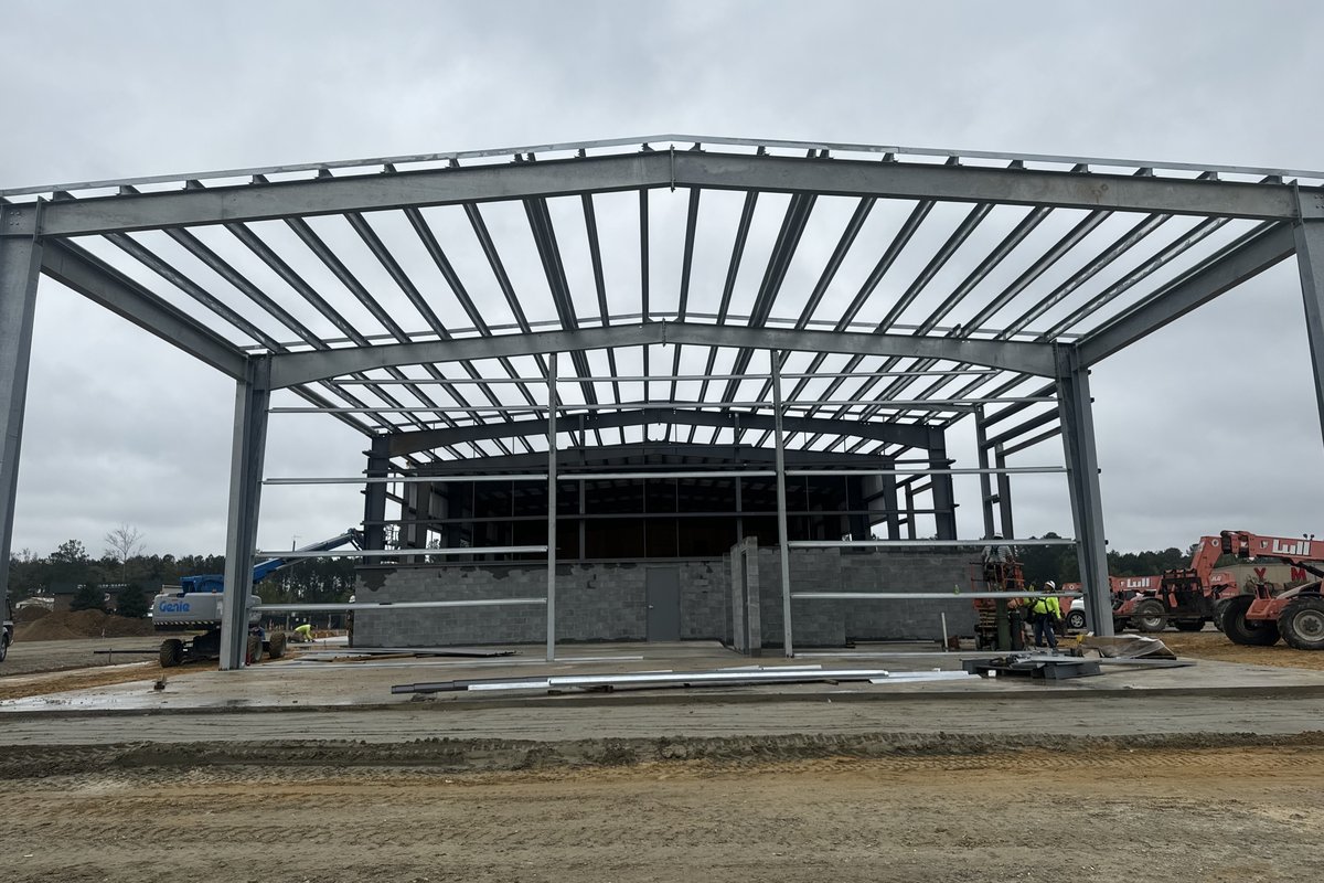 Pre-engineered metal building frame with masonry walls under construction